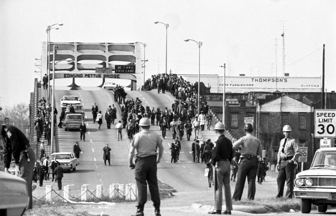 State troopers watch on March 9, 1965, as marchers cross the Edmund Pettus Bridge in Selma, Alabama, to campaign for voting rights.