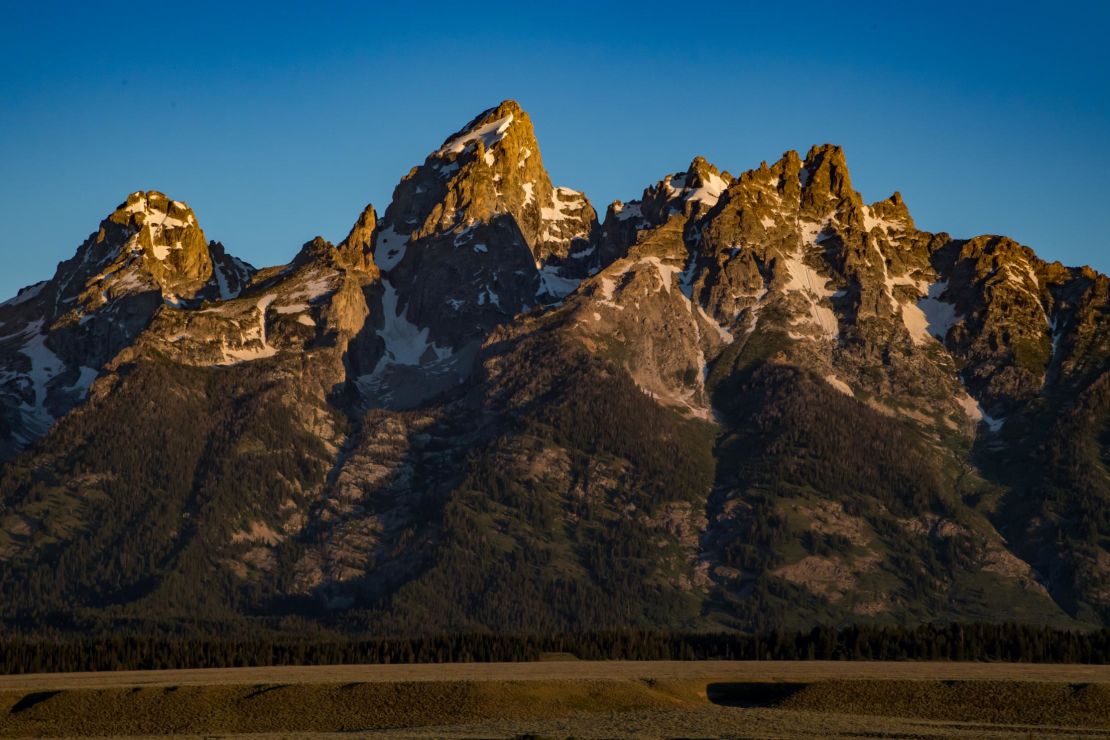 The Teton Range, a mountain range of the Rocky Mountains, is seen as the sun rises.