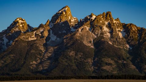The Teton Range, a mountain range of the Rocky Mountains, is seen as the sun rises.