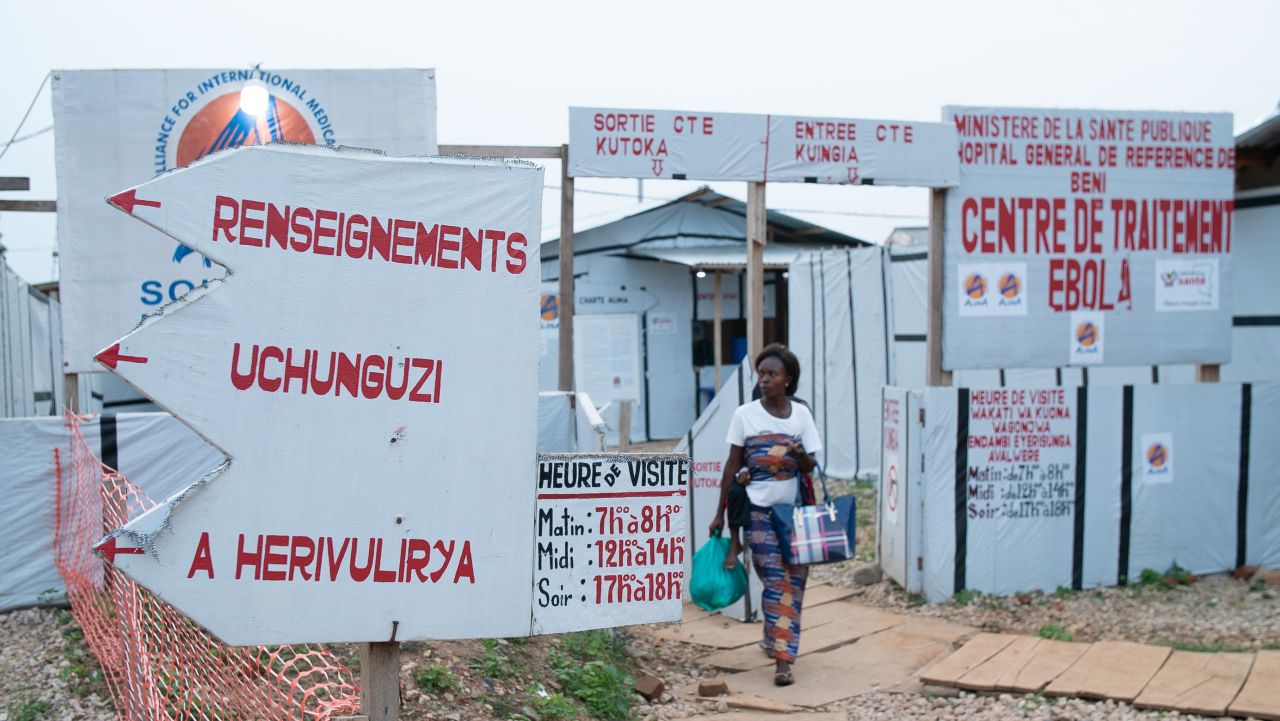 A woman leaves an Ebola treatment center in Beni, in the eastern part of the Democratic Republic of Congo (DRC). Mistrust and insecurity have stopped many from getting treatment. In this outbreak, up to a third of Ebola cases are confirmed only after their bodies are discovered in the community.