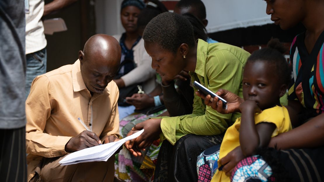 A health worker talks to people who have been designated to get an experimental vaccine. Contacts of Ebola victims and health workers have been vaccinated in this outbreak. But it hasn't stopped the spread. And some are too afraid to get the vaccine.