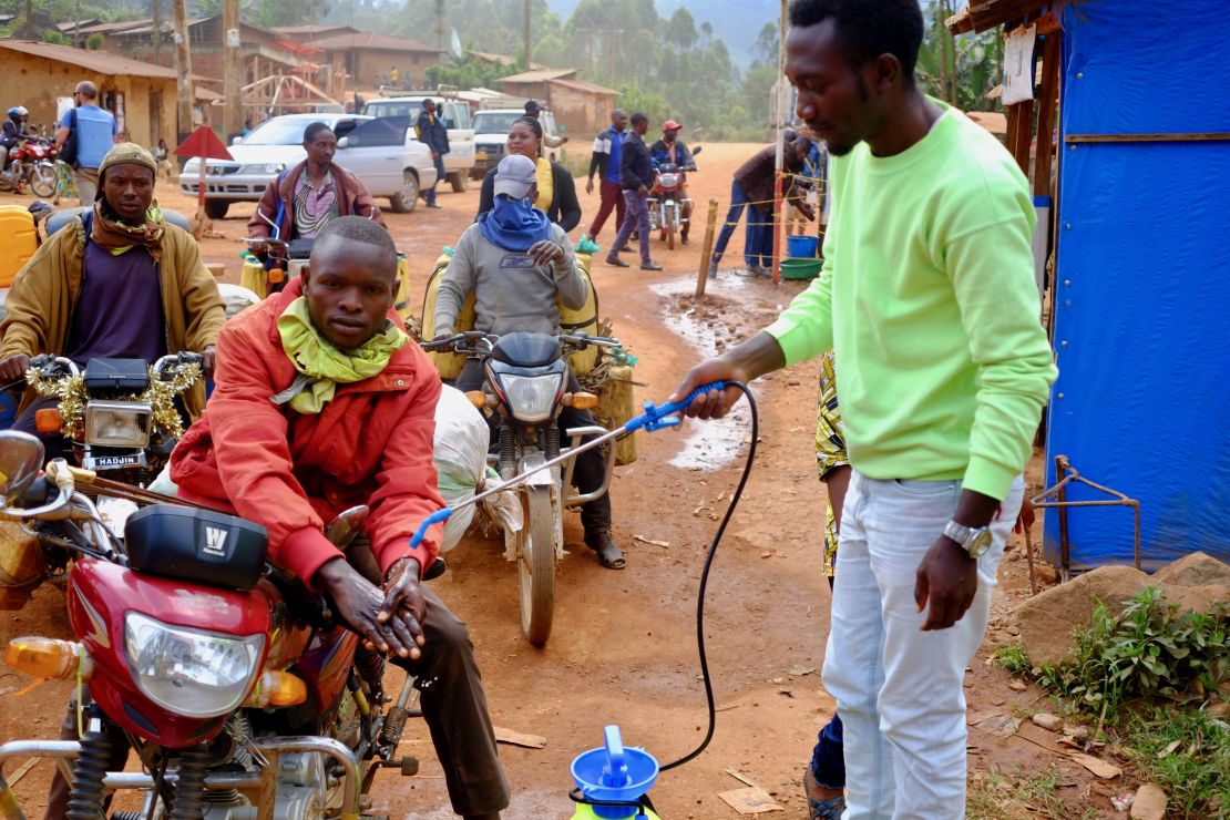 A taxi driver gets his hands washed with a chlorine solution at a checkpoint between Beni and Butembo in Eastern DRC. 