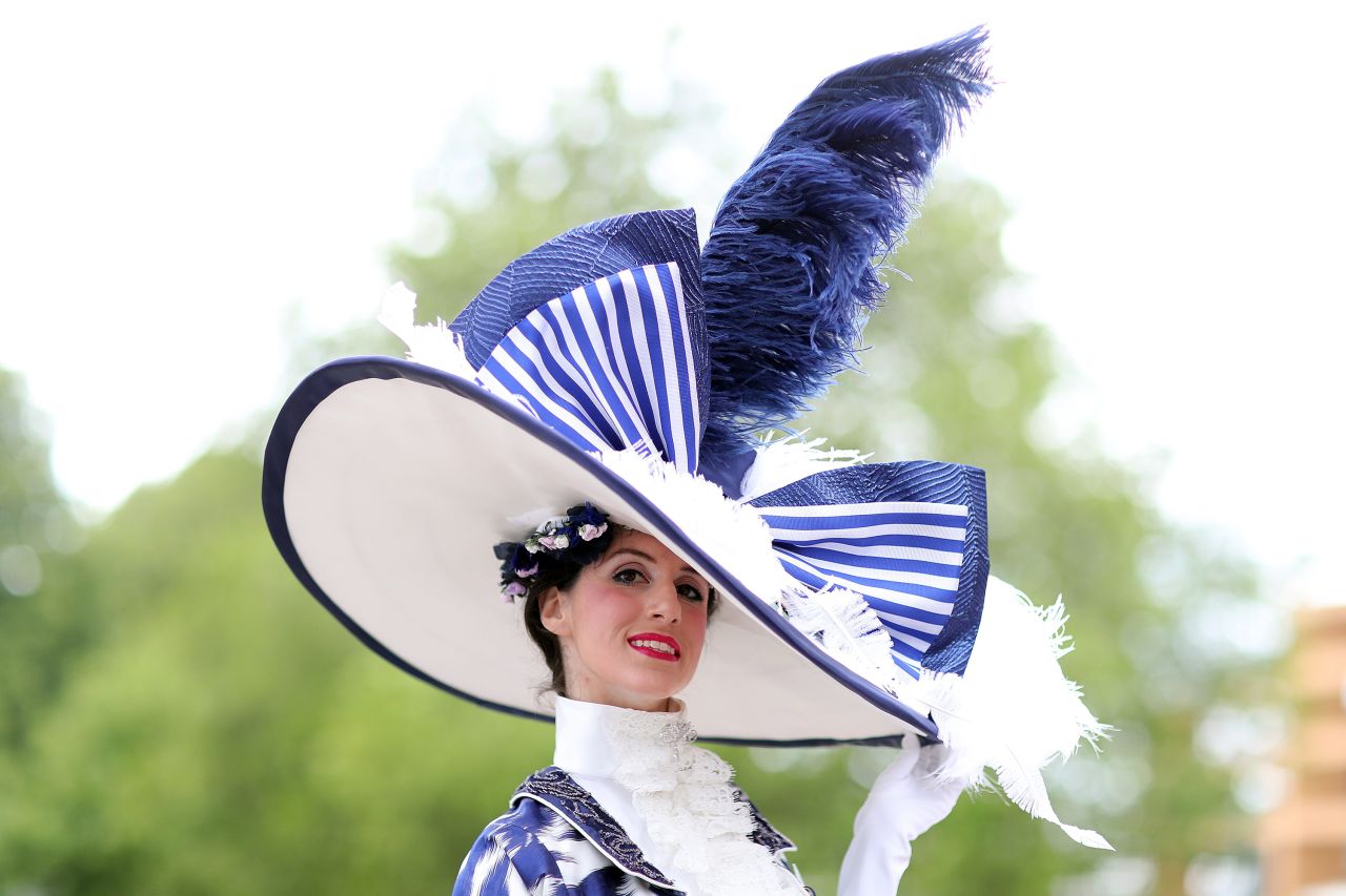A racegoer takes Royal Ascot's famous dress code to new heights with a larger-than-life hat. 