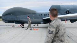 A team of 12th Aircraft Maintenance Unit Airmen walk beside an RQ-4 Global Hawk while it's being towed during Red Flag Alaska 18-3, Aug. 16, 2018, at Eielson Air Force Base, Alaska. This marks the first time an RQ-4 has landed in Alaska during a simulated combat training exercise. (U.S. Air Force photo by Airman 1st Class Tristan D. Viglianco)
