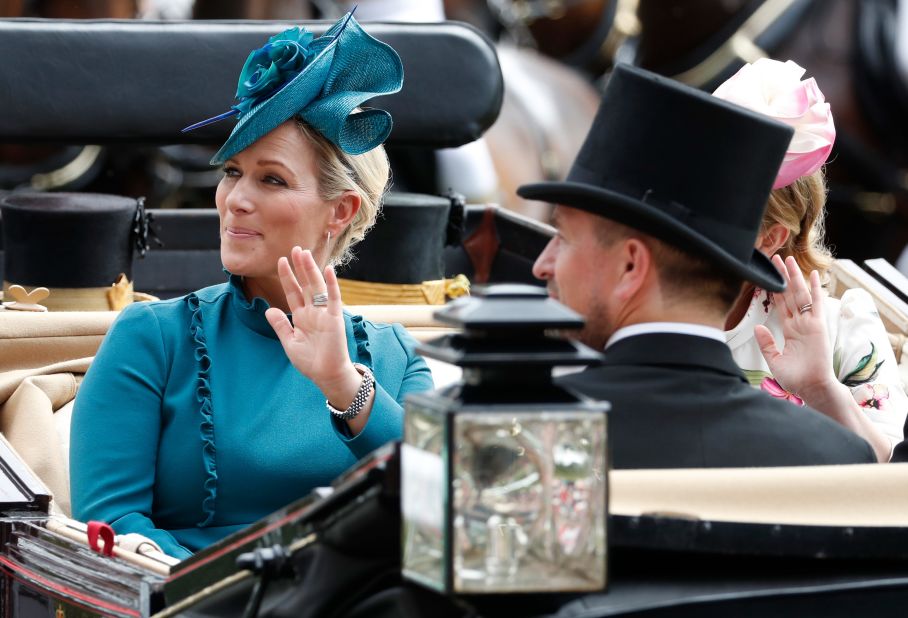 The Queen's eldest granddaughter, Zara Tindall, waves to the crowd in a teal hat and matching dress. 