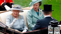 Britain's Queen Elizabeth II (L) and Britain's Princess Anne, Princess Royal, arrive by horse-drawn carriage to attend day three of the Royal Ascot horse racing meet, in Ascot, west of London, on June 20, 2019. - The five-day meeting is one of the highlights of the horse racing calendar. Horse racing has been held at the famous Berkshire course since 1711 and tradition is a hallmark of the meeting. Top hats and tails remain compulsory in parts of the course while a daily procession of horse-drawn carriages brings the Queen to the course. (Photo by Adrian DENNIS / AFP)        (Photo credit should read ADRIAN DENNIS/AFP/Getty Images)