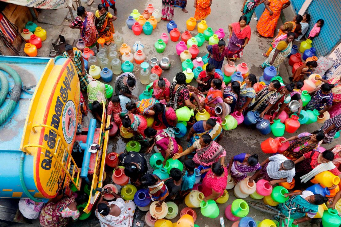 Chennai residents line up to fill containers of water from a tanker.