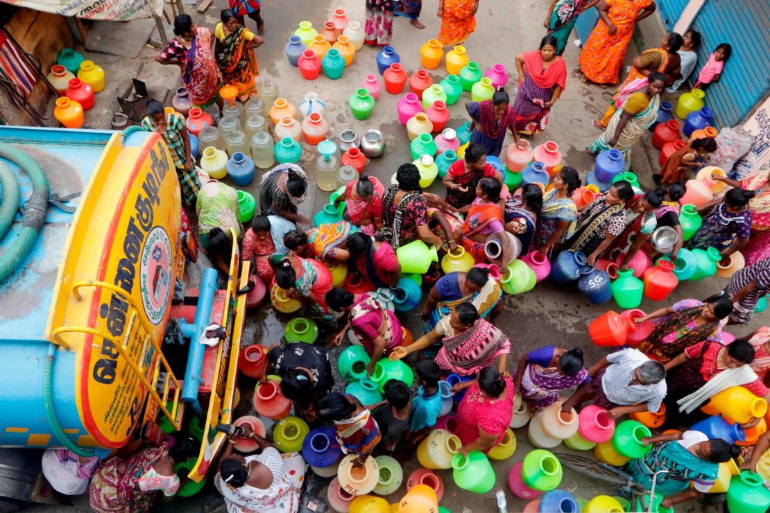 Chennai residents line up to fill vessels with water from a tanker.