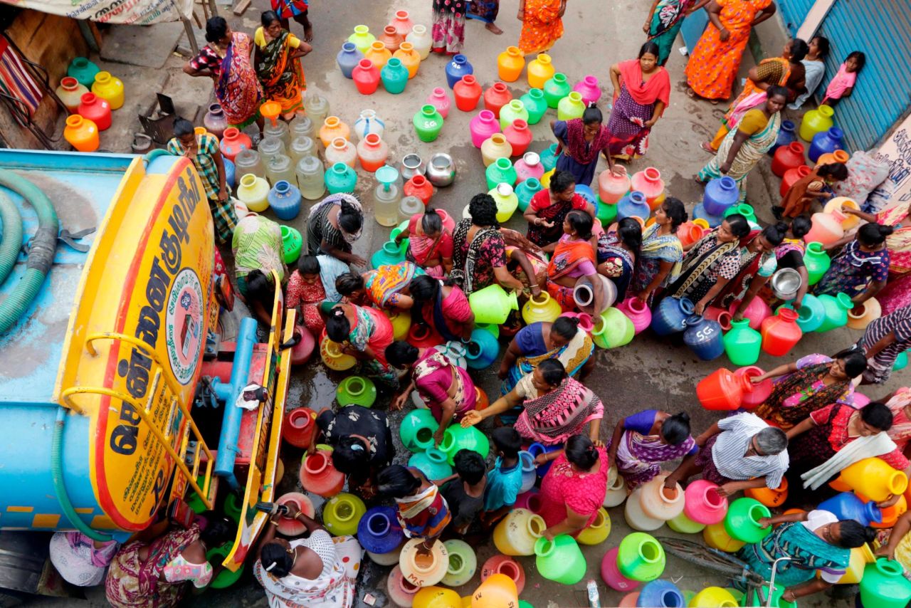 People stand in line to get water from a tanker in Chennai on June 19. With low groundwater levels and insufficient rainwater collection systems, the state government has resorted to trucking water directly into neighborhoods.