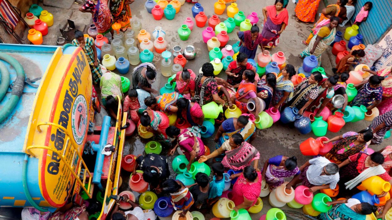 Chennai residents line up to fill vessels with water from a tanker.