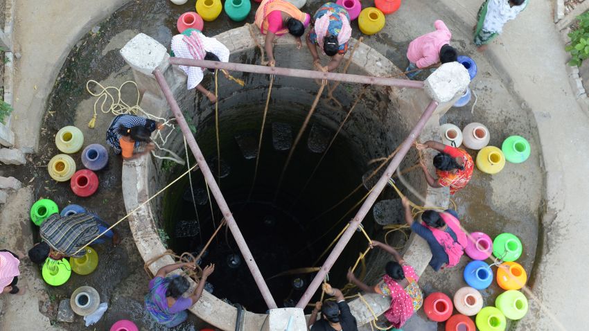Indian residents fetch drinking water from a well in the outskirts of Chennai on May 29, 2019. - Water levels in the four main reservoirs in Chennai have fallen to one of its lowest levels in 70 years, according to Indian media reports. (Photo by ARUN SANKAR / AFP)        (Photo credit should read ARUN SANKAR/AFP/Getty Images)