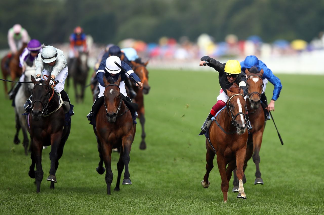 Frankie Dettori (yellow cap) and Stradivarius hold off Dee Ex Bee and Master of Reality to clinch a famous win on  Ladies' Day at Royal Ascot.