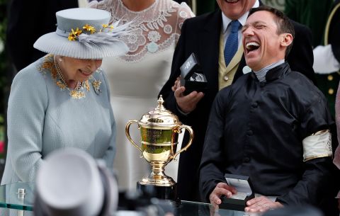 Britain's Queen Elizabeth II presents jockey Frankie Dettori with the Gold Cup after his second straight win on Stradivarius.