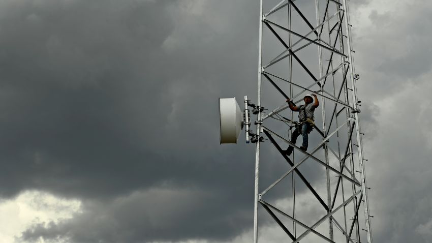 MEEKER, CO - AUGUST: Jackson Federico, a tower technician for Advanced Wireless Solutions, carefully makes his way along tower struts to the dishes on the Pollard cell tower high off the ground in rural Rio Blanco County  on July 12, 2017 near Meeker, Colorado.  Broadband in Rio Blanco county and Meeker is some of the best in the state for rural areas. Federico was on the tower to make some repairs to the dish. (Photo by Helen H. Richardson/MediaNews Group/The Denver Post via Getty Images)
