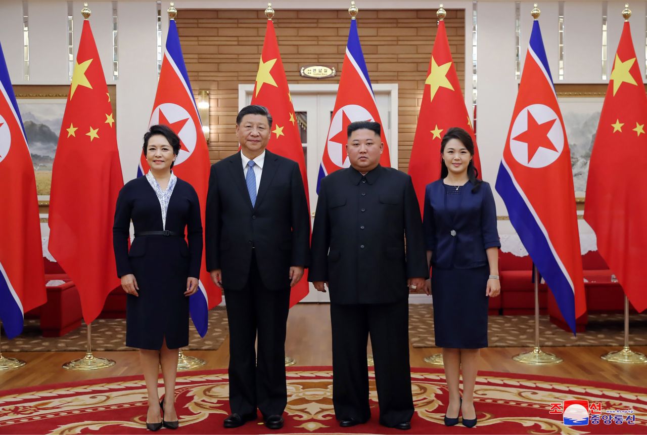 Kim, center right; his wife Ri Sol Ju, right;  Xi, center left; and his wife Peng Liyuan pose for a photo at Kumsusan guest house in Pyongyang, North Korea.