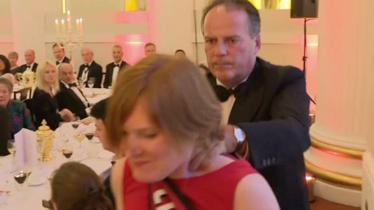 British lawmaker Mark Field pushes a Greenpeace protester out of an event in London.