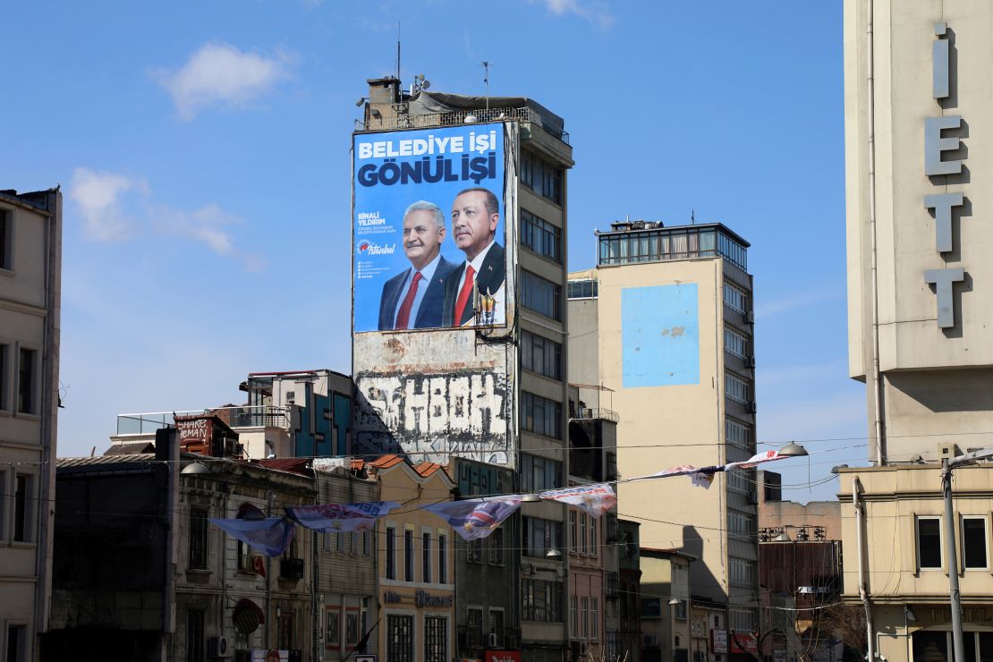 An AKP election banner featuring Y?ld?r?m and Erdo?an hangs from an Istanbul building ahead of the March election.