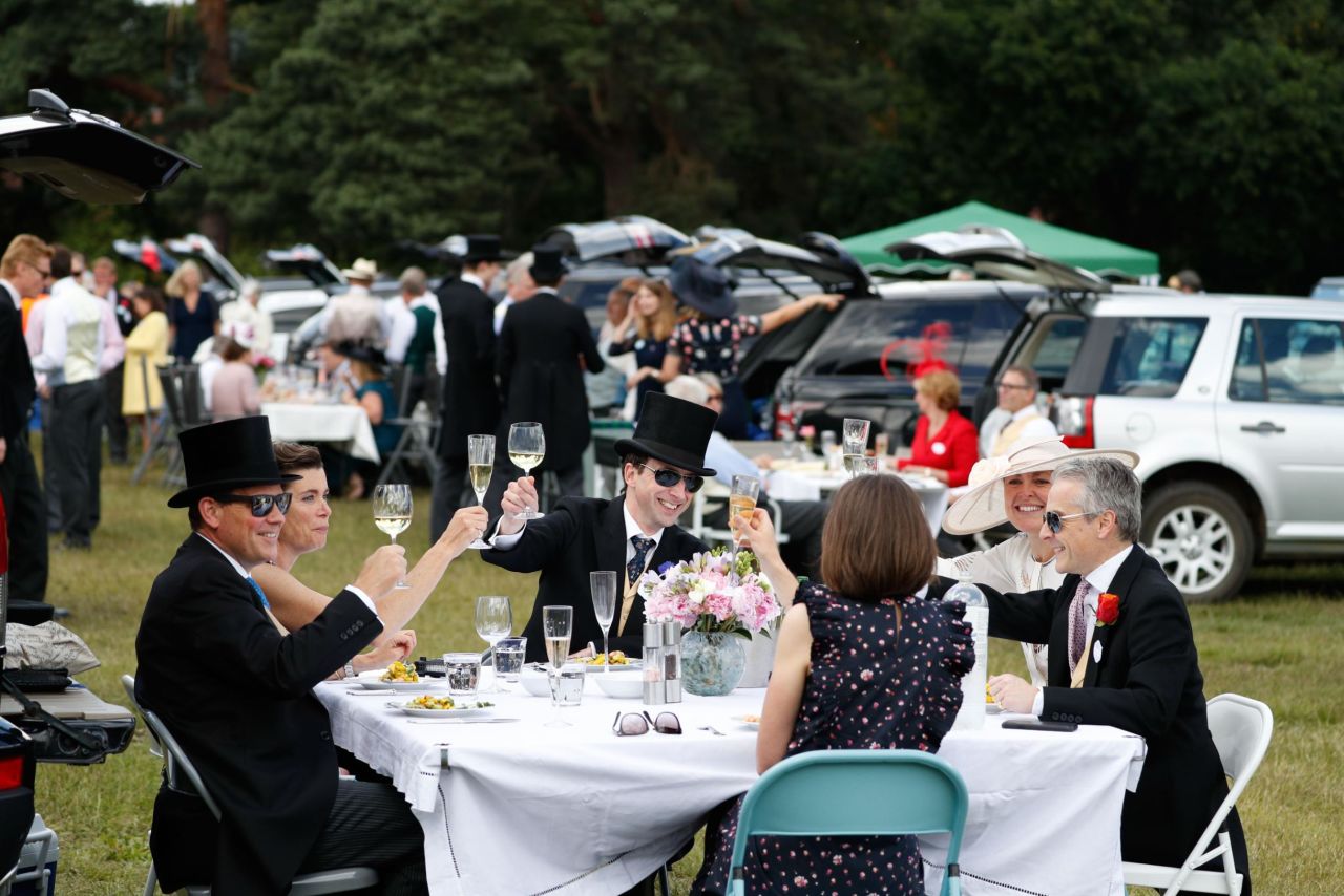 After a wet week, the sun is out at Ascot and racegoers are able to enjoy picnics in the car park.