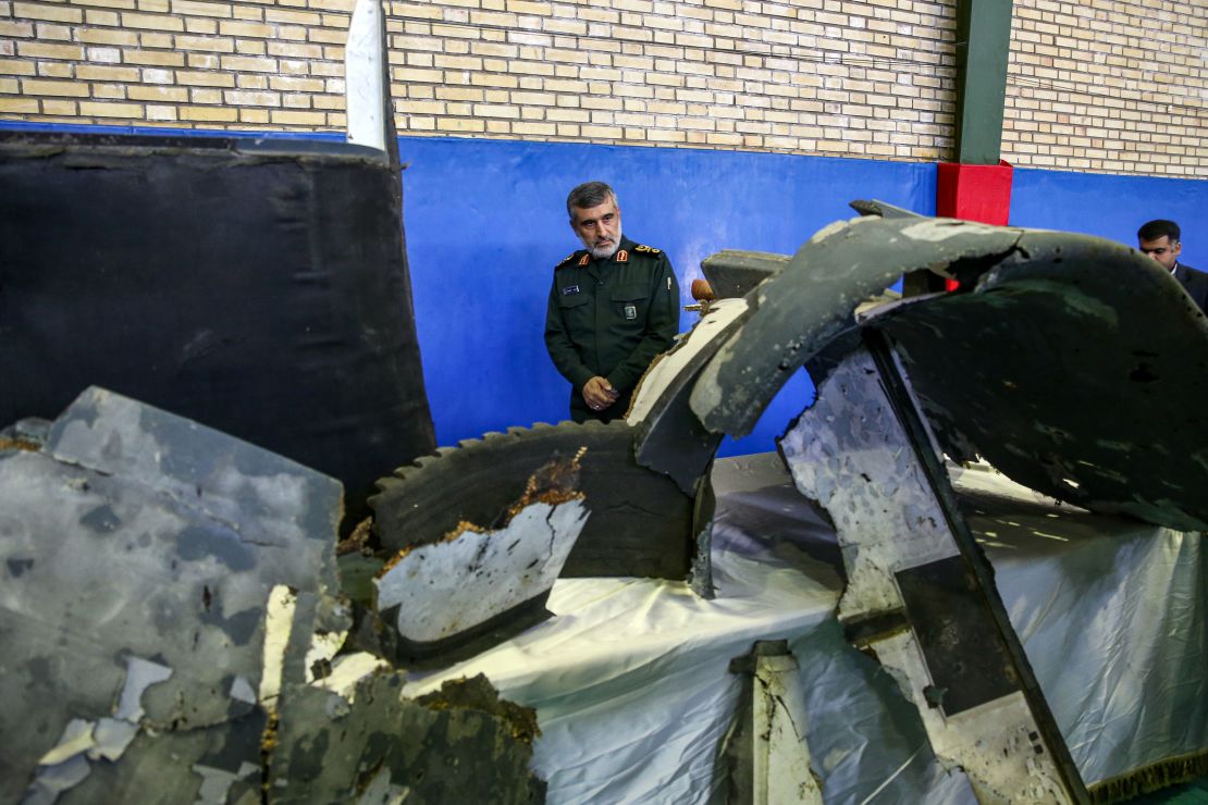 General Amir Ali Hajizadeh, Iran's Head of the Revolutionary Guard's aerospace division, looks at debris from a downed US drone reportedly recovered within Iran's territorial waters on Friday. 