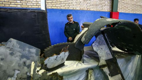 Gen. Amir Ali Hajizadeh, Iran's head of the Revolutionary Guard's aerospace division, looks at debris from a downed US drone on June 21, 2019.