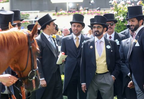 Dubai ruler Sheikh Mohammed bin Rashid Al Maktoum (yellow waistcoat) is head of the Godolphin racing operation and a familiar face at British horse racing tracks. 