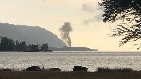 A plume of smoke rises after the plane crash at Dillingham Airfield on Oahu's North Shore.