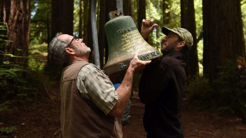 UC Santa Cruz employees David Jessen, left, and Mitch Smith remove a mission bell from campus Friday.