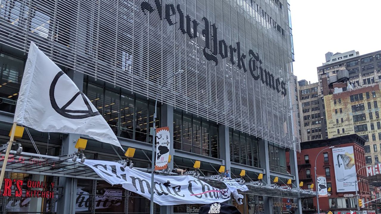 Signs and flags are seen waving outside of The New York Times offices in New York during the protest Saturday.