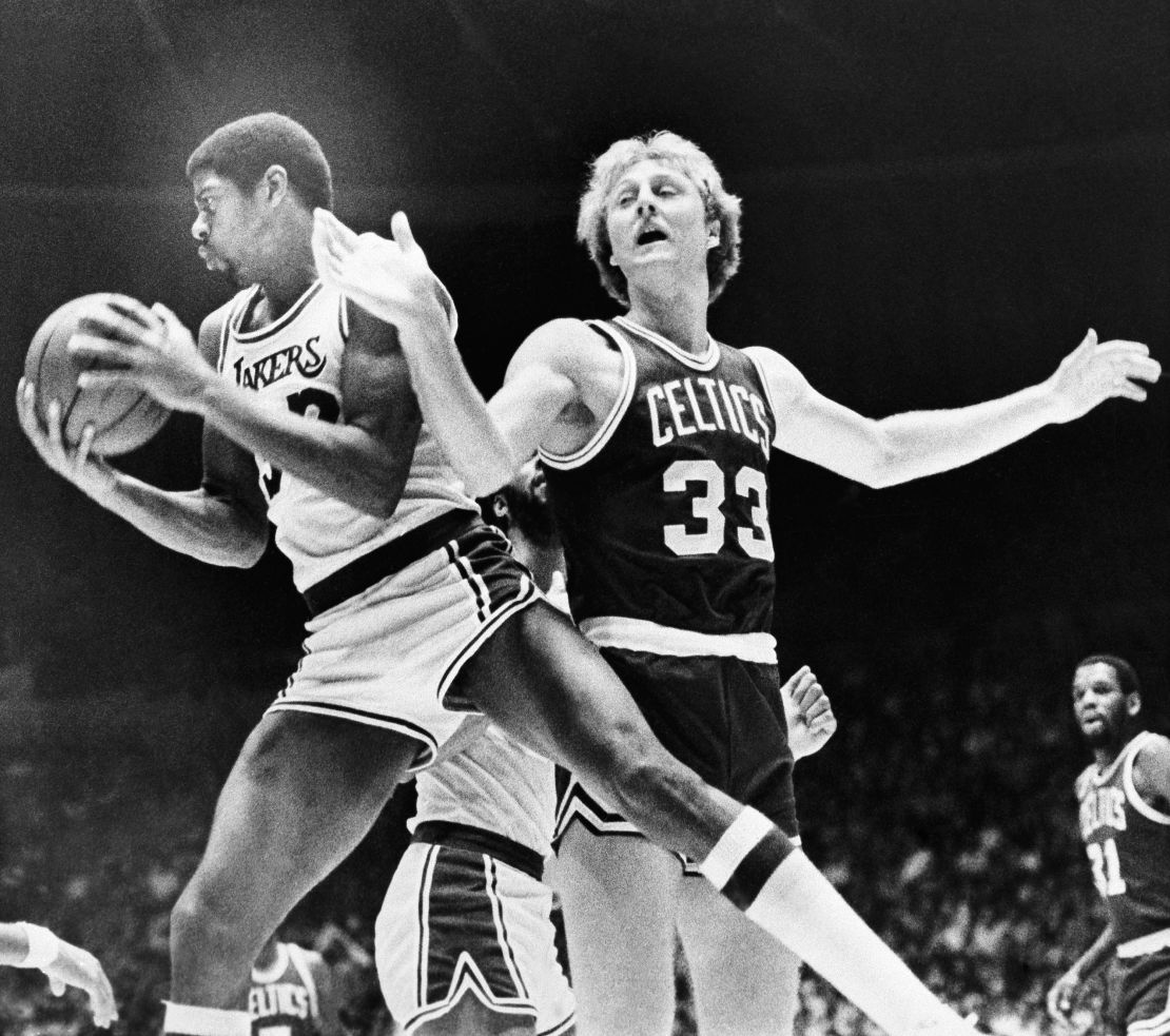 Johnson rips a rebound from Bird's hands during the first half on December 28, 1979 in Los Angeles.