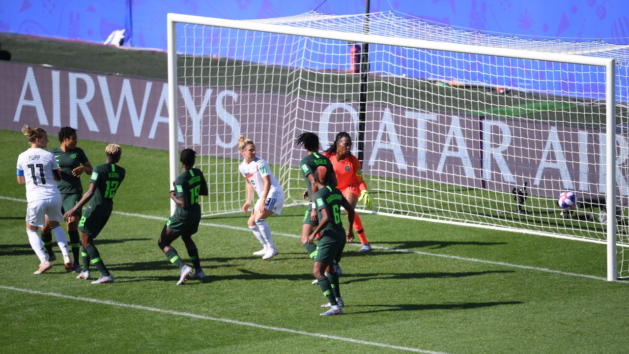 Popp scores for Germany while teammate Huth is in front of the last defender as the ball is played. 