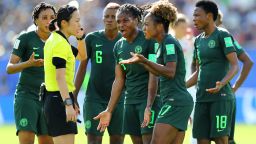 GRENOBLE, FRANCE - JUNE 22: Nigeria players confront referee Yoshimi Yamashita after she awards Germany a penalty during the 2019 FIFA Women's World Cup France Round Of 16 match between Germany and Nigeria at Stade des Alpes on June 22, 2019 in Grenoble, France. (Photo by Elsa/Getty Images)