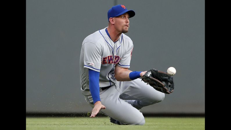 New York Mets left fielder Jeff McNeil dives for a ball hit by Josh Donaldson of the Atlanta Braves during the first inning of an MLB game in Atlanta on Monday, June 17. McNeil failed to make the catch.