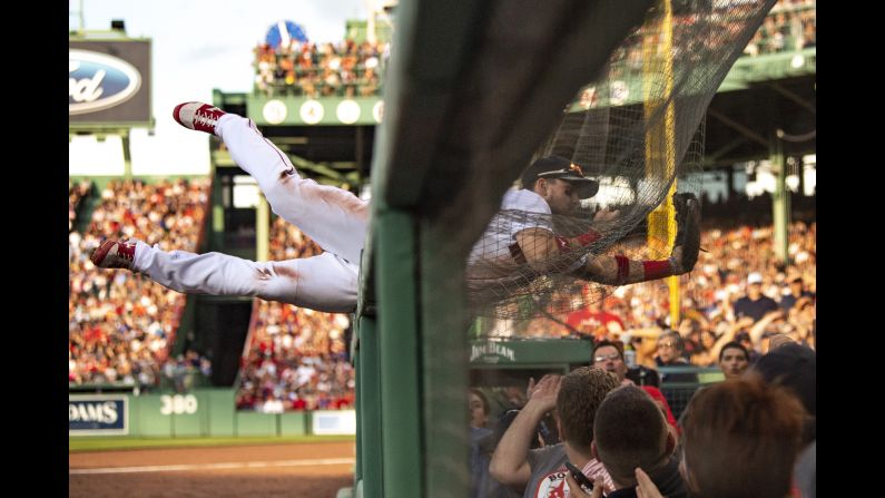 Michael Chavis of the Boston Red Sox dives into the netting as he attempts to catch a fly ball during the seventh inning of a game against the Toronto Blue Jays at Fenway Park in Boston on Saturday, June 22.