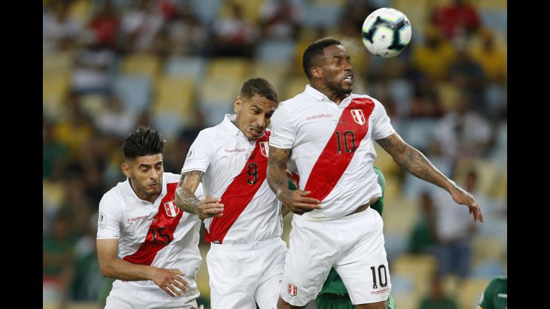 Jefferson Farfan of Peru heads the ball near teammates Paolo Guerrero and Carlos Zambrano during the Copa America group A match between Bolivia and Peru at Maracana Stadium in Rio de Janeiro, Brazil on Tuesday, June 18.