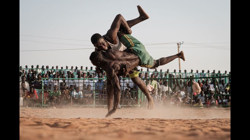 Sudanese wrestlers fight during a traditional Nuba wrestling match at the Haj Youssef stadium in the district of Khartoum, Sudan on June 21.