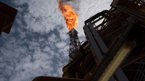 A view of the flare of the Kaombo Norte, an oil tanker converted into a FPSO vessel (Floating Production Storage and Offloading), owned by the French Total oil company, on November 8, 2018, about 250km off the coast of Angola in the Atlantic Ocean. - Moored in the endless South Atlantic Ocean far off the coast of Angola, the "Kaombo Norte" oil-extraction vessel is a deeply impressive sight -- 330 metres long, with a tower 110 metres high sending a burning flame into the sky. But inside, daily life on the ship is a different matter, with a crew of about 100 sharing narrow passages and confined spaces, living for weeks at a stretch in close quarters 24 hours a day. (Photo by Rodger BOSCH / AFP) (Photo credit should read RODGER BOSCH/AFP/Getty Images)