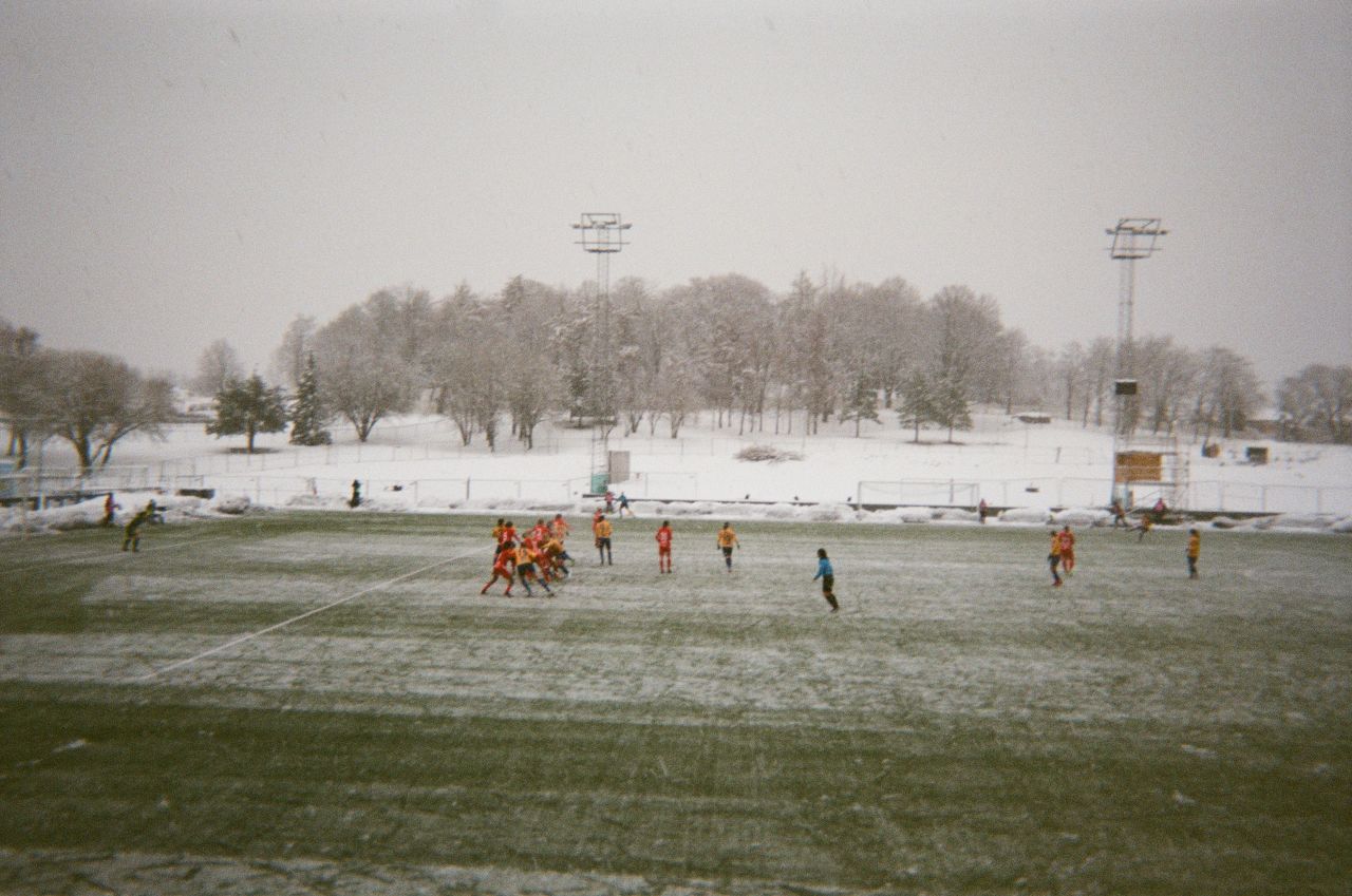 <strong>Photographer:</strong> Lauren Silver, Jamaica & Trondheims-ørn<br /><strong>Location: </strong>Trondheim, Norway<br /><br />"My team Trondheims-ørn was playing against another top division Norwegian team. That week it had been snowing intensely and it sure didn't stop for the game. I couldn't play this game because my paperwork for the team was not complete. So I was sitting in the stands watching. Practicing and playing in the snow is really hard. Everything is cold and my toes always go numb, plus the ground is really slippery because the ice melts, then freezes on the ground. If you look in the background, you can see pile on piles of snow. My team was fighting hard and we came out with a 0-0 tie. These photos show one side of Norway. Some days it is very nice, especially during spring. But during the winter, the snow definitely comes in waves. It's cool that football takes me to places like Norway. Sometimes I take a step back to really remember and appreciate that."