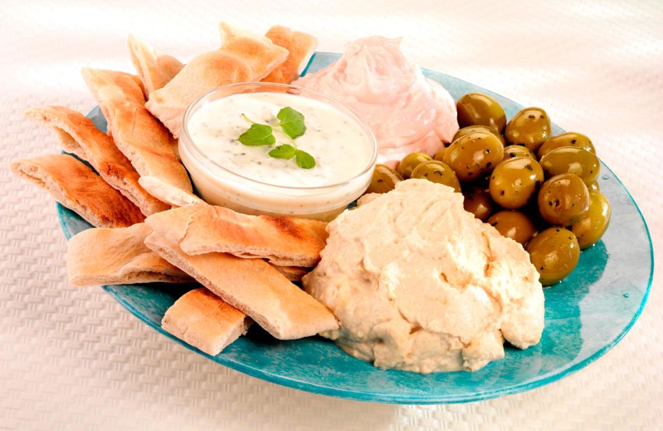 <strong>Taramasalata (Ταραμοσαλάτα): </strong>Pictured with fellow Greek  appetizers, taramasalata is naturally a gray-yellow color, but is usually dyed pink. 