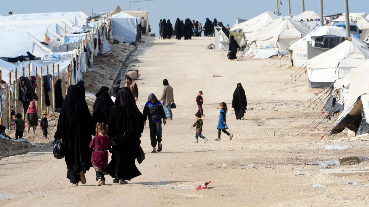 Veiled women, living in al-Hol camp which houses relatives of ISIS group members, walk in the camp in al-Hasakeh governorate in northeastern Syria on March 28, 2019. 