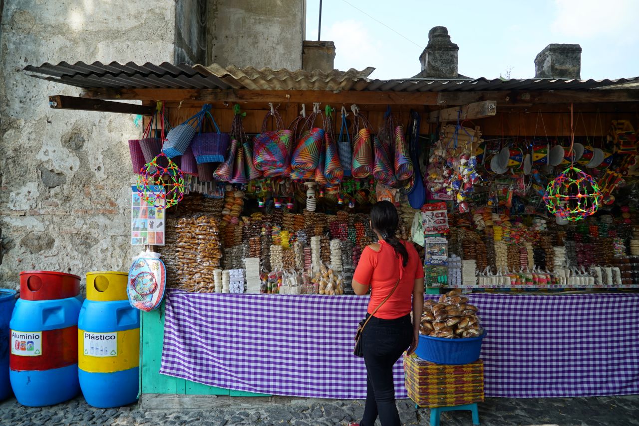 <strong>Sweet stuff: </strong>A woman ponders the vast selection of sweets at a stall in the square adjacent to the Iglesia y Convento de Santo Domingo church in Antigua.