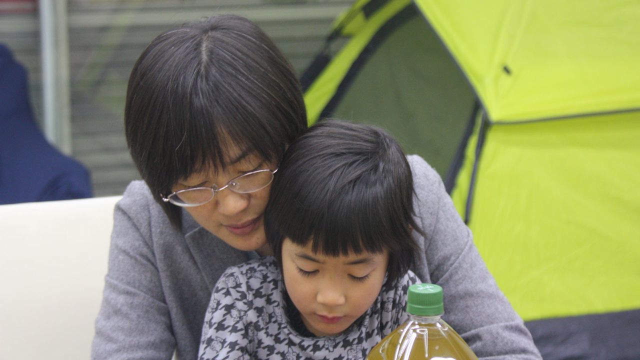 Kumamoto City Councilwoman Yuka Ogata hangs out with her daughter while waiting to meet with local moms.