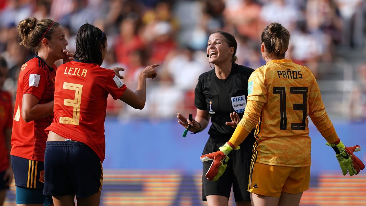 Referee Katalin Kulcsar argues with Spain's defender Leila Ouahabi (2ndL) and Spain's goalkeeper Sandra Panos (R) after giving a penalty kick.