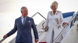 Britain's Prince Charles, Prince of Wales (L) and his wife Britain's Camilla, Duchess of Cornwall (R) disembark from the plane upon their arrival at the airport in Banjul, for an official visit, on October 31, 2018. (Photo by Seyllou / POOL / AFP)        (Photo credit should read SEYLLOU/AFP/Getty Images)