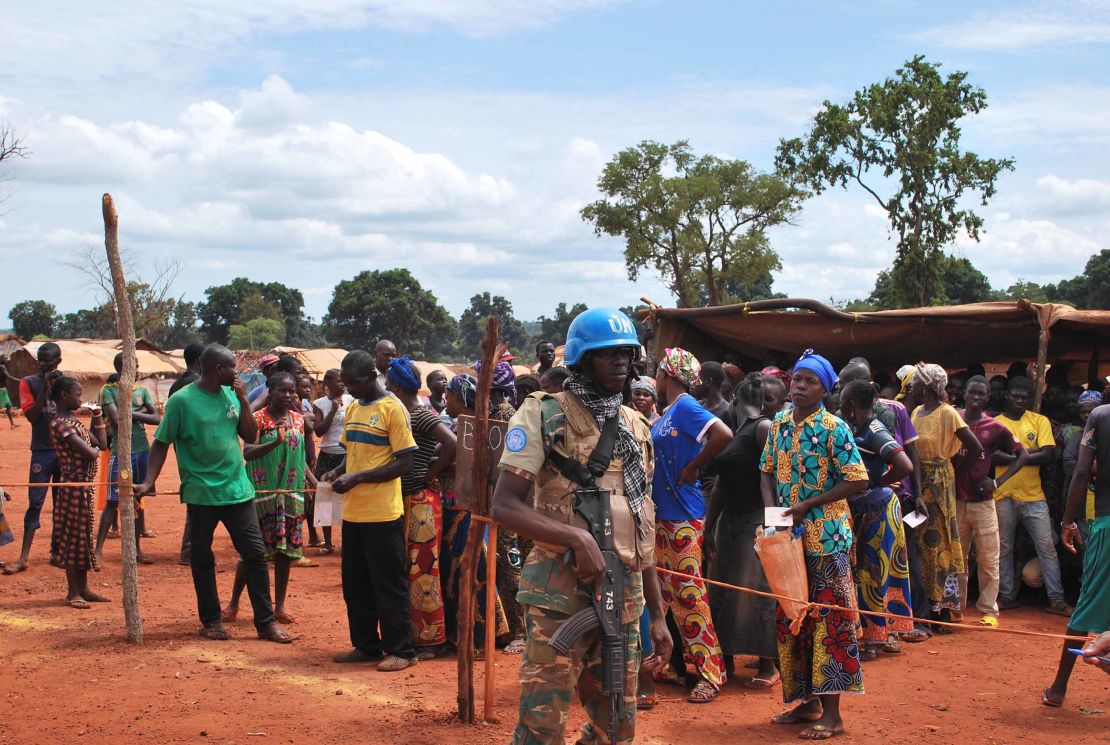 Namibian UN blue helmets stand watch over food distribution at the camp.