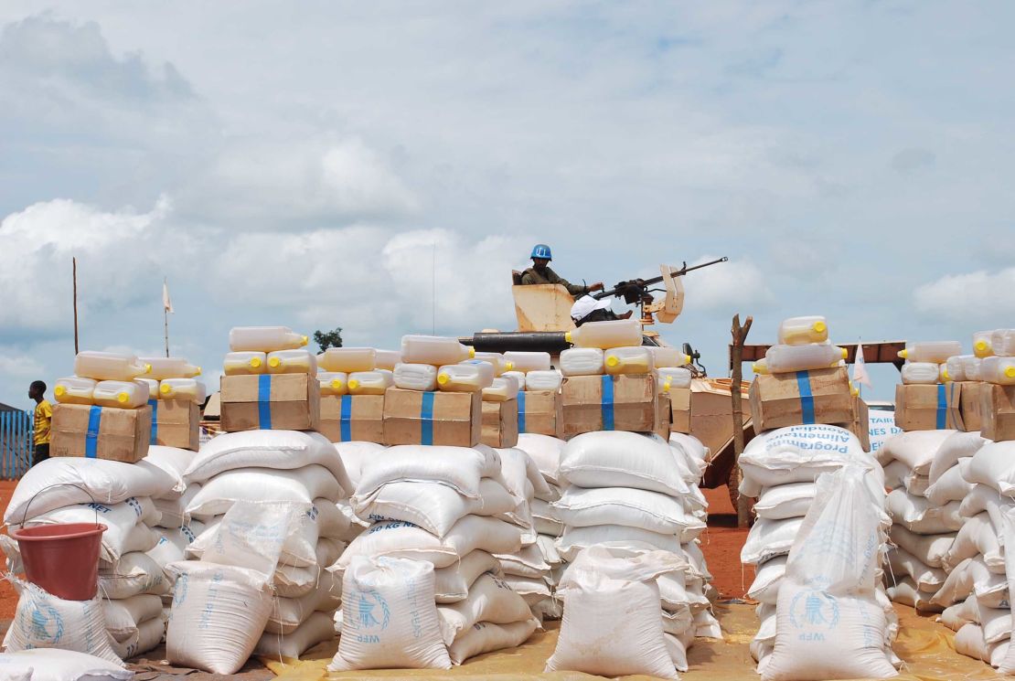 A member of the UN forces guards rations of rice and oil for the sanctuary at Bria.