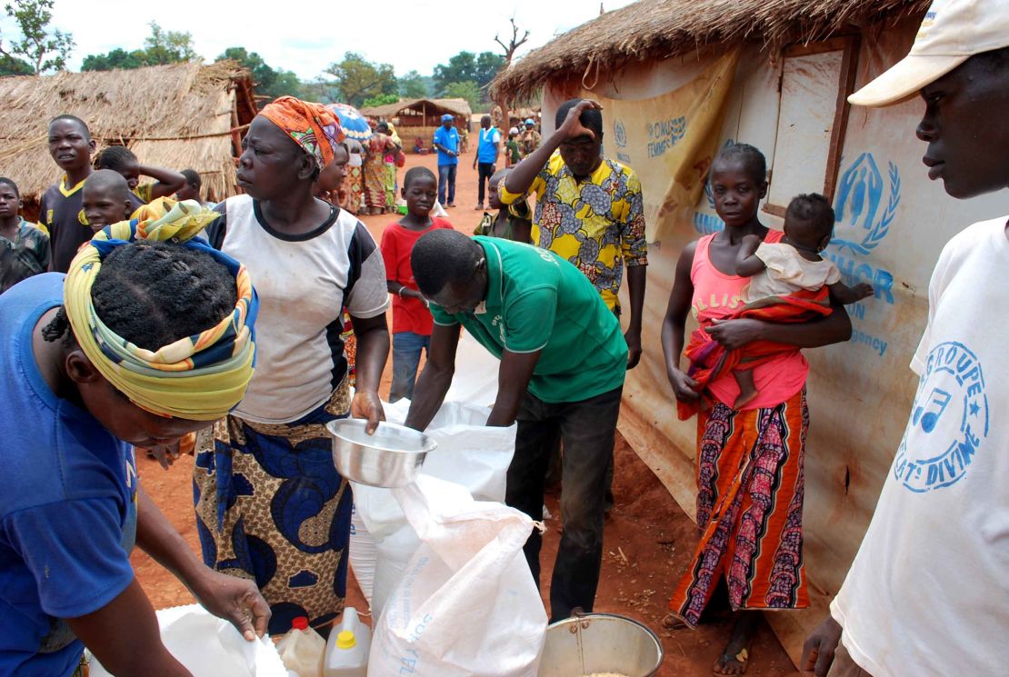 People living in the Bria camp collect rations.