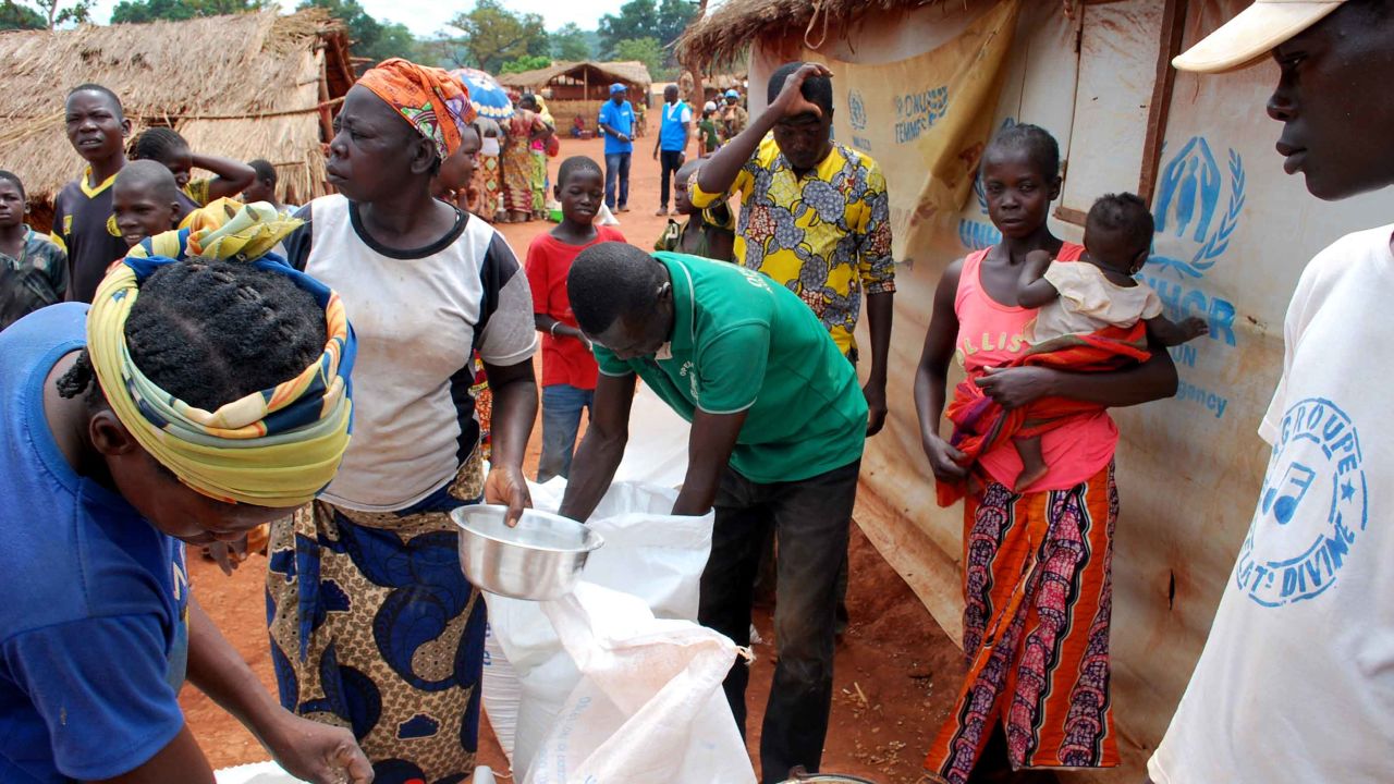 People living in the Bria camp collect rations.