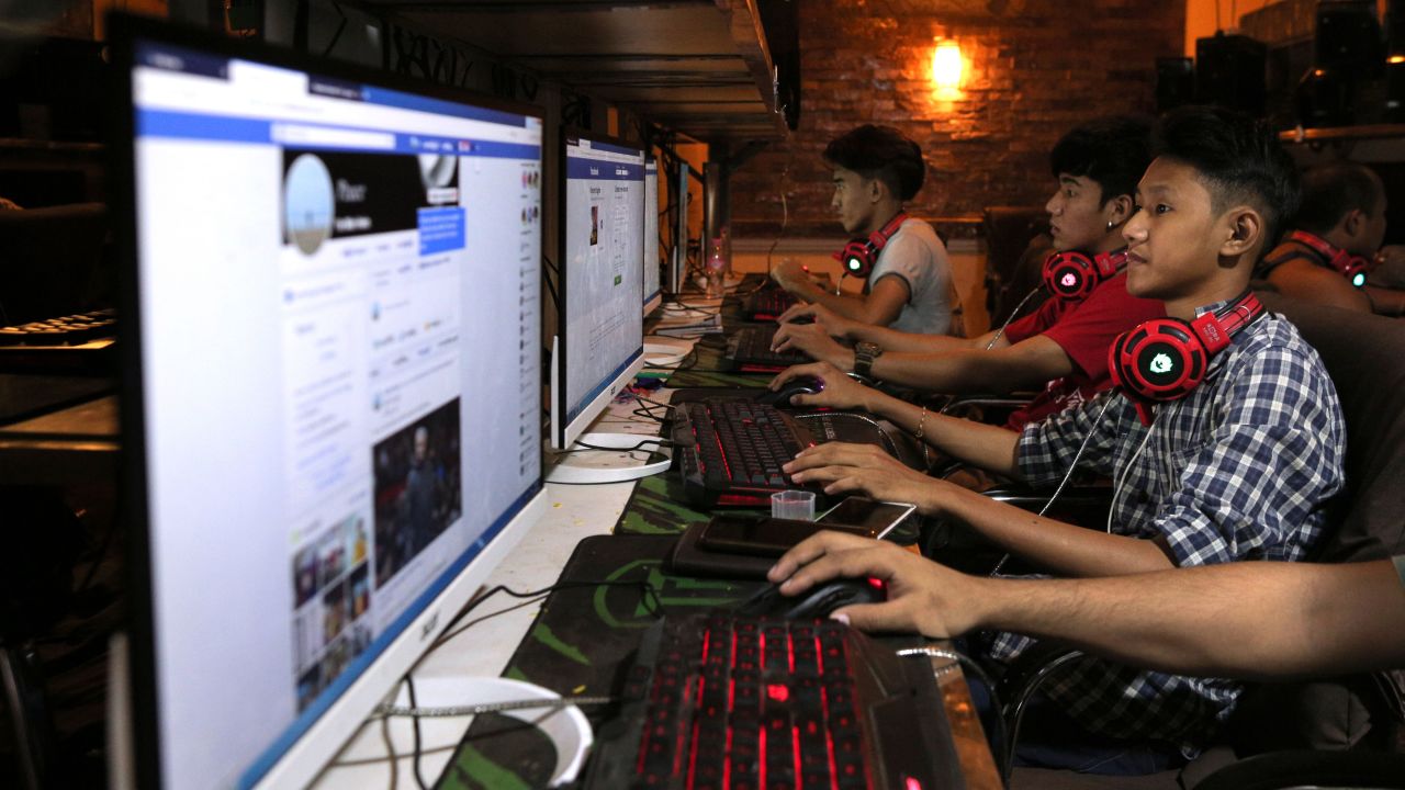 This picture taken on December 18, 2018 shows Myanmar youths browsing their Facebook page at an internet shop in Yangon. Internet services in the west of the country have been shut off since June 20.
