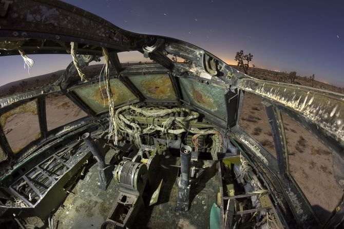 Joshua trees peek out behind the rusted frame of a Boeing B-52 Stratofortress. Like many of Paiva's photos, the image explores the interaction between nature and technology. 