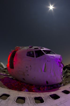 Paiva's book explores how state-of-the art technology turns into ruins. In this image, the front section of a Boeing 737 lies decaying in the desert.